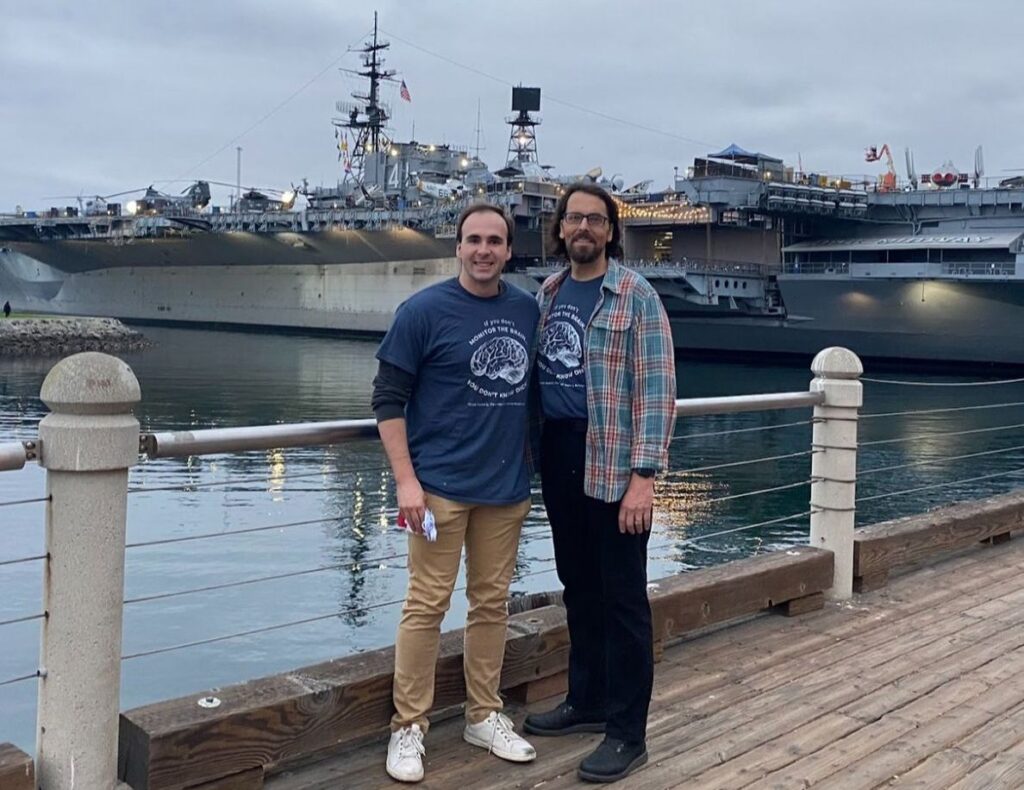 Ethan Moyer and Craig Maddux by the USS Midway Aircraft Carrier