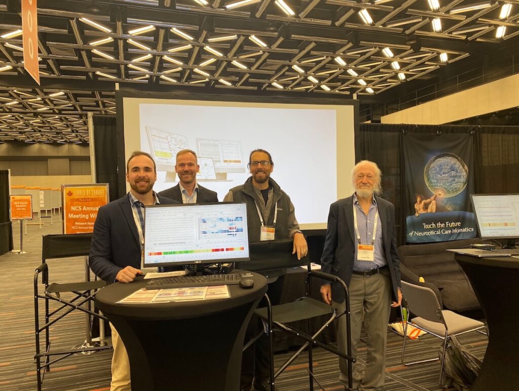 Ethan Moyer, Tobias Hamann (Neuroviso, European distributor of MCP), Craig Maddux, and Dick Moberg manning the booth.